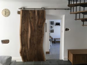 Sliding door made from a slab of wood
