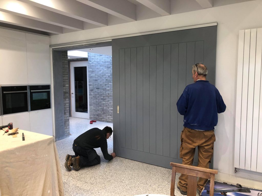 Men installing a sliding door