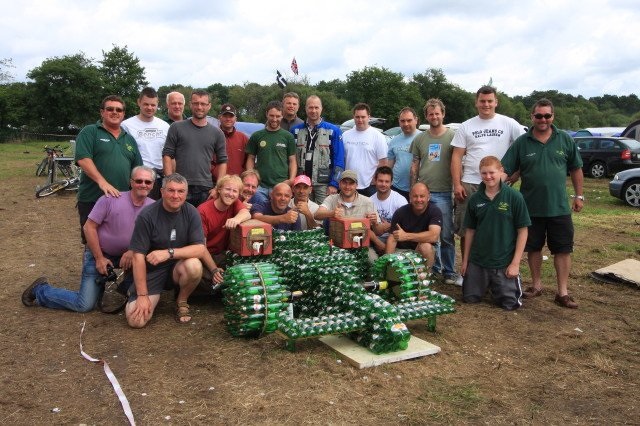 Group of men with a replica formula 1 car made of glass bottles